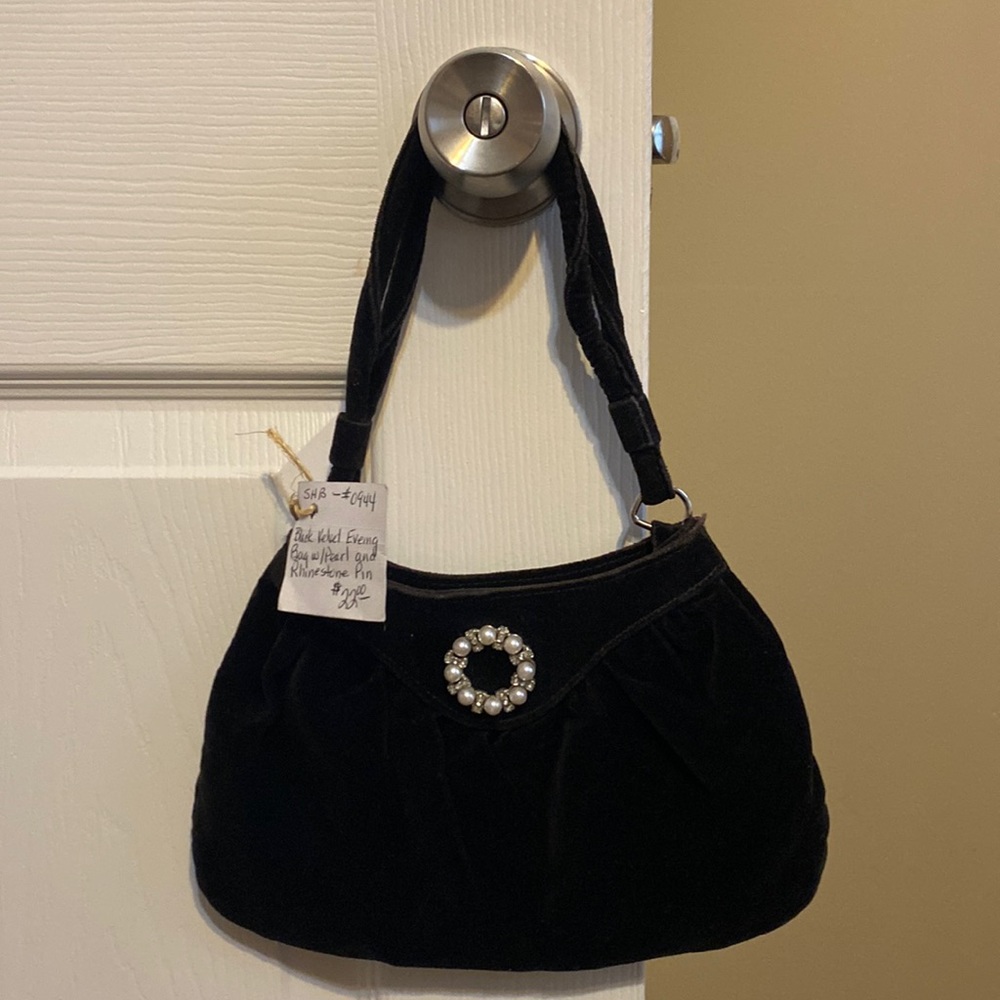 Black velvet evening back with pearl and rhinestone pin